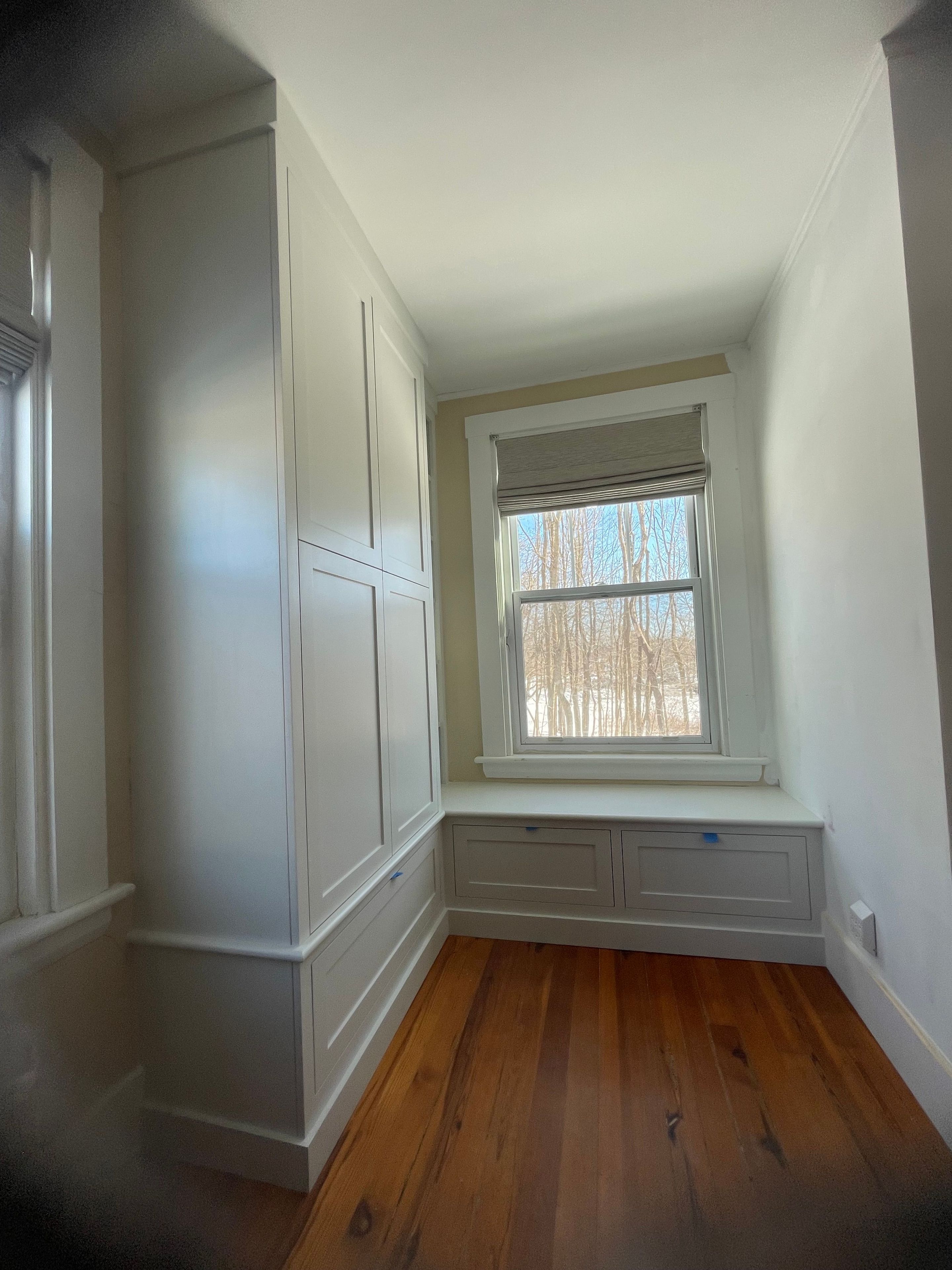 Custom nook bench with pullout drawers and armoire with shelving